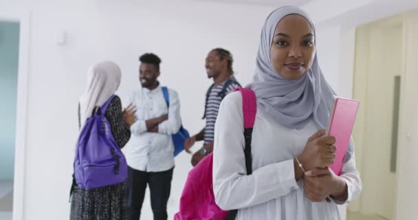 Afrikai diáklány baráti társasággal a háttérben hagyományos iszlám hidzsáb ruhát visel — Stock videók