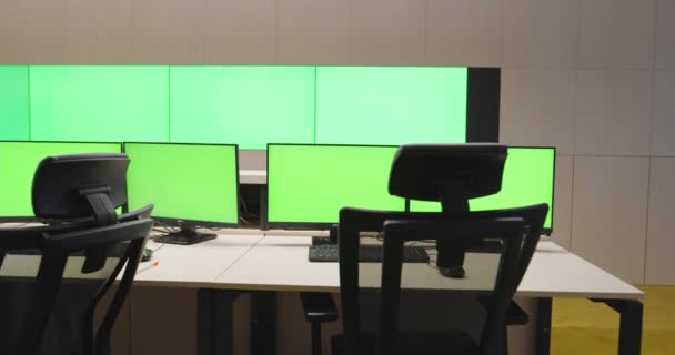 Modern faclity of security or surveillance center with many monitors and cctv cameras with green screan, concept of protection and security with chroma key — Stock Video