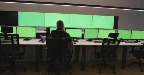 System Security Specialist Working at System Control Center. Room is Full of Green Screens, Chroma screen and security — Stock Video