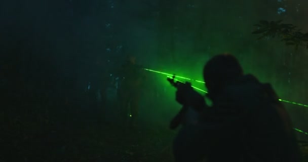 Special Forces soldiers in action. Elite squad attacking terrorists in forest at night, fire and military action — Stock Video