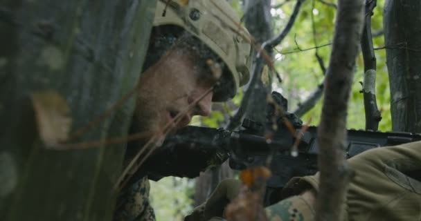 Volledig uitgeruste geweer soldaat met camouflage uniform aanvallende vijand, geweer in vuurpositie in dichte bos — Stockvideo