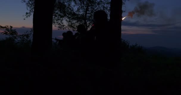 Military action taking place in forest at nigh time. Saving solider and using flares to light and signal their position — Stock Video