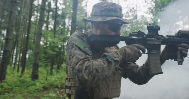 Soldat zielt aus Gewehr im Wald, Rauch im Hintergrund, Militär- und Armeekonzept — Stockvideo