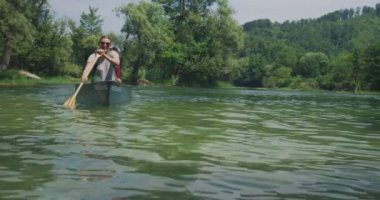 Nehirde kayak yapan ve doğada macera yaşayan bir çift.