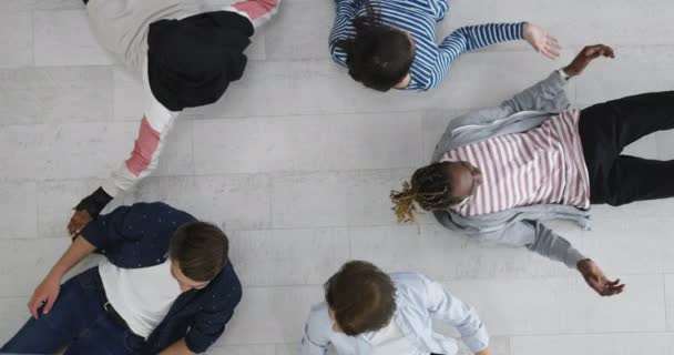 Multiethnic Group of Friends in a Circle lying on floor — Stock Video