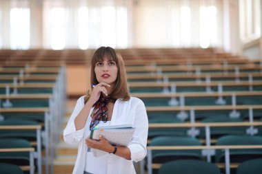 Ünlü öğrenci kalem ve defter kullanıyor.