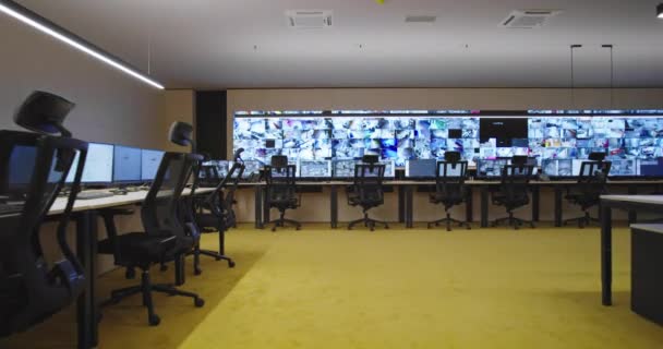 Empty office, desk, and chairs at a main CCTV security data center. — Stock Video