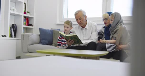 Muslim family generations grandparents reading Quran with grandchildren at home — Stock Video