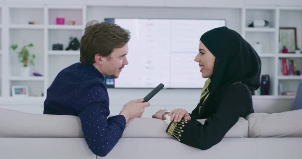 Muslim couple watching TV during ramadan — Stock Video