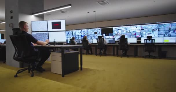 Security guards monitoring modern CCTV cameras in surveillance room — Stock Video