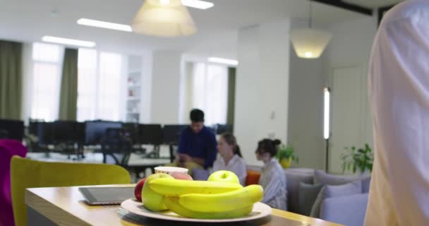 Frau mit Hidschab trifft Geschäftsmann im Startup-Büro, gesunder Lebensstil im Büro, Apfel und Obst essen im Büro — Stockvideo