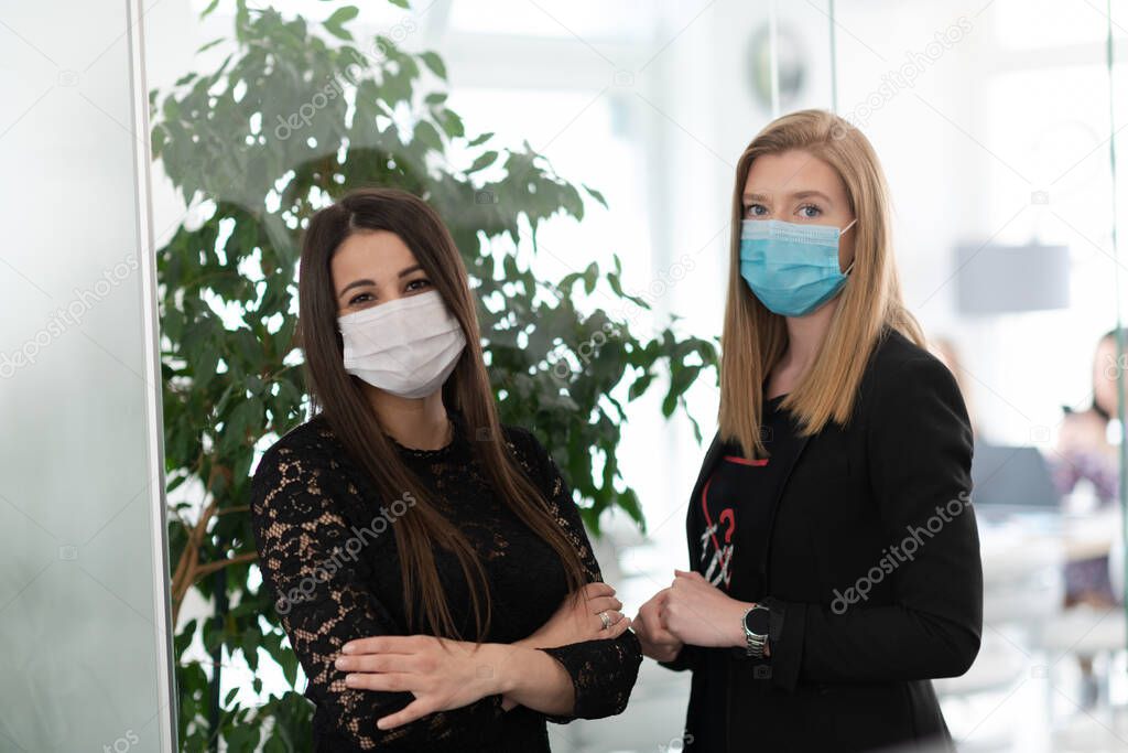 business team in protective medical mask at modern office