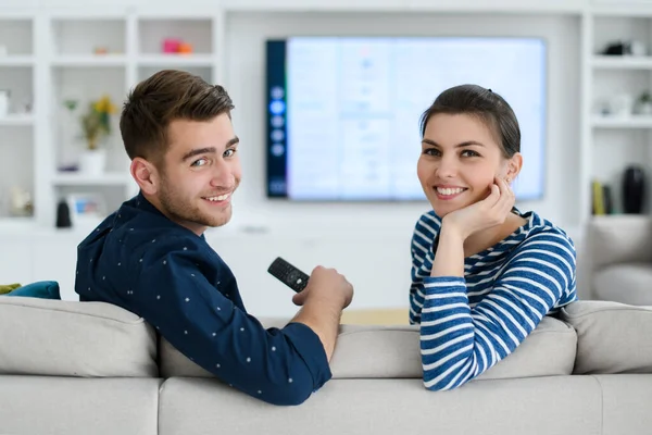 Una joven pareja de casados disfruta sentado en la gran sala de estar — Foto de Stock