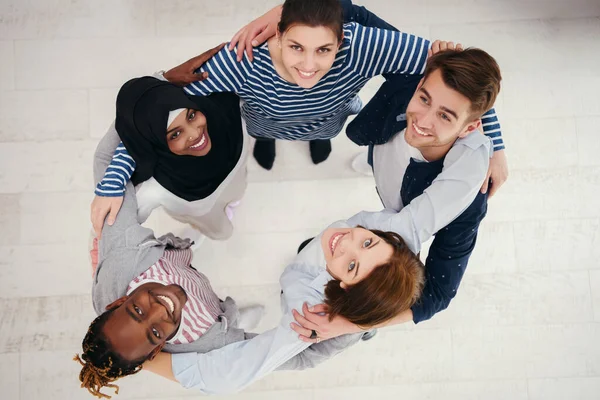 a top view of diverse group of people standing embracing and symbolizing togetherness.