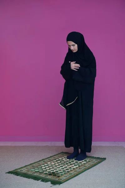 ナマズのムスリム女性は神であるアッラーに祈ります 伝統的な中東の服で祈るカーペットの上のイスラム教徒の女性 ヒジャーブ州の女性 — ストック写真