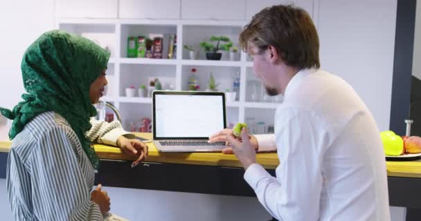 Startup company with two people using laptop at meeting — Stock Video