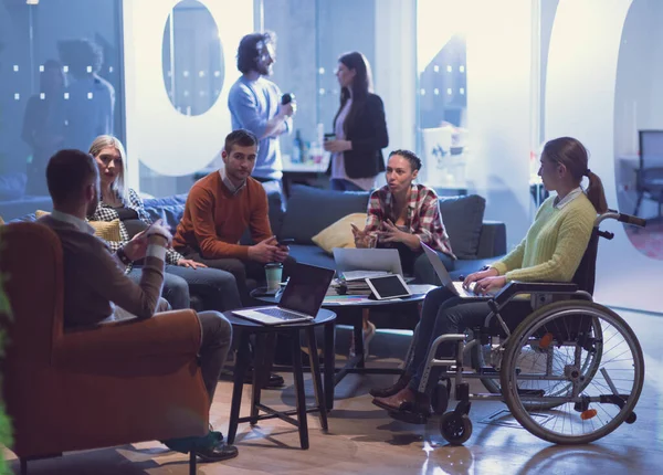 Handicapperd businesswoman in a wheelchair on meeting with her diverse business team brainstorming at office — Stock Photo, Image