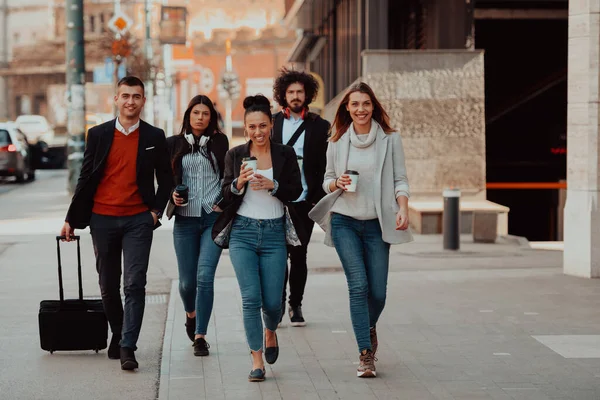 Elegant businesspeople walking in a modern city after hard workig day