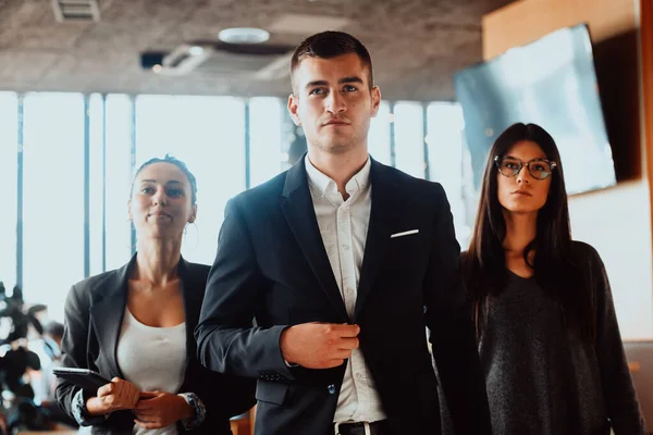 Group of successful business people standing together at modern coworking office. — стоковое фото