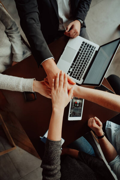 young business people putting their hands together. Stack of hands. Unity and teamwork concept.