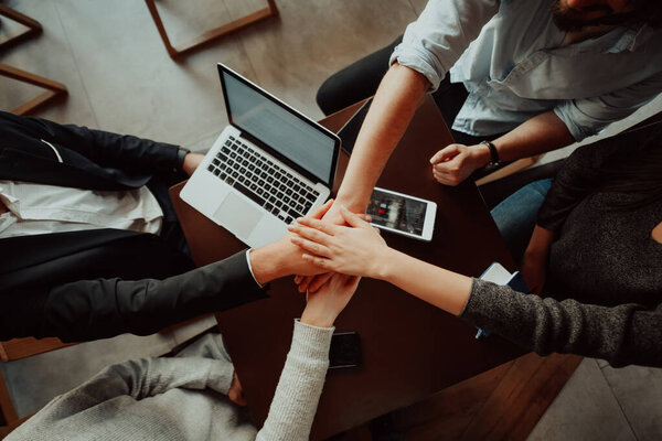 young business people putting their hands together. Stack of hands. Unity and teamwork concept.