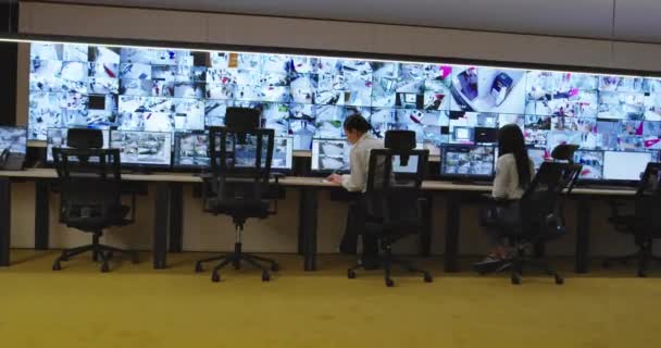 Guardias de seguridad monitoreando cámaras de CCTV modernas en la sala de vigilancia — Vídeos de Stock