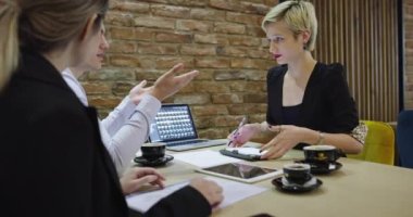 Bir grup genç iş adamı bir masada bir araya gelerek ilginç bir fikri tartıştılar ve kafeteryada beyin fırtınası yaptılar.