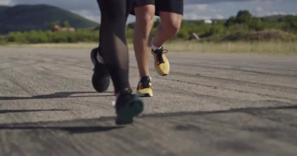 Pernas Fechar câmera lenta ajuste casal jogging exercício execução cardio treino. — Vídeo de Stock
