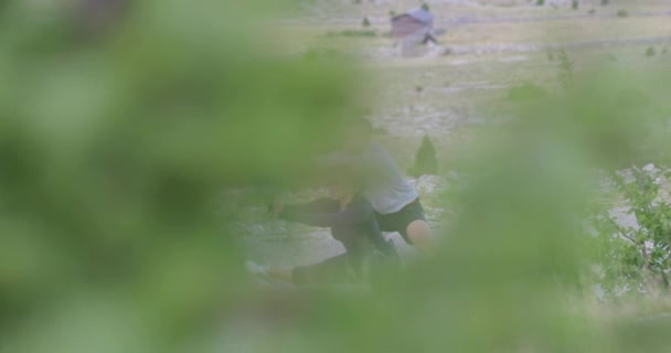 Reveal slow motion shot of a determined couple of athletes stretching together, warming up and preparing for running training on a panoramic road. — Stock Video