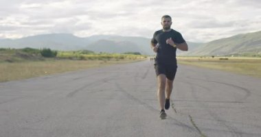 Jogger during intense training in the morning. Runner sprinting during outdoors training for marathon run.