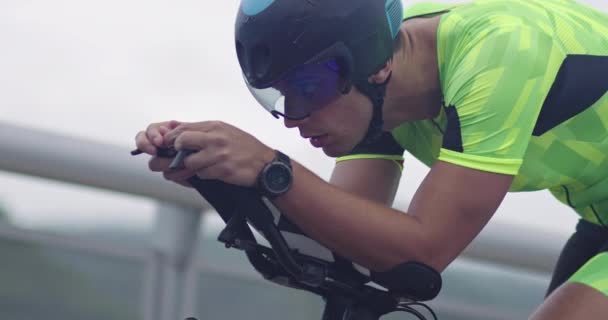 Closeup shot of triathlon sportsman athlete cyclist riding professional racing bicycle. — Stock Video