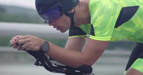 Closeup shot of triathlon sportsman athlete cyclist riding professional racing bicycle. — Video