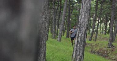Running man outdoors. Male runner jogging in the forest. 