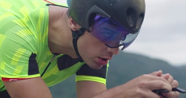 Closeup shot of triathlon sportsman athlete cyclist riding professional racing bicycle. — Stock Video