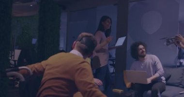 Tekerlekli sandalyedeki engelli işadamı, sanal gerçeklik gözlüğü ve insansız hava aracı simülasyonu kullanarak takım toplantısı için modern açık alan ofisinde çalışıyor.