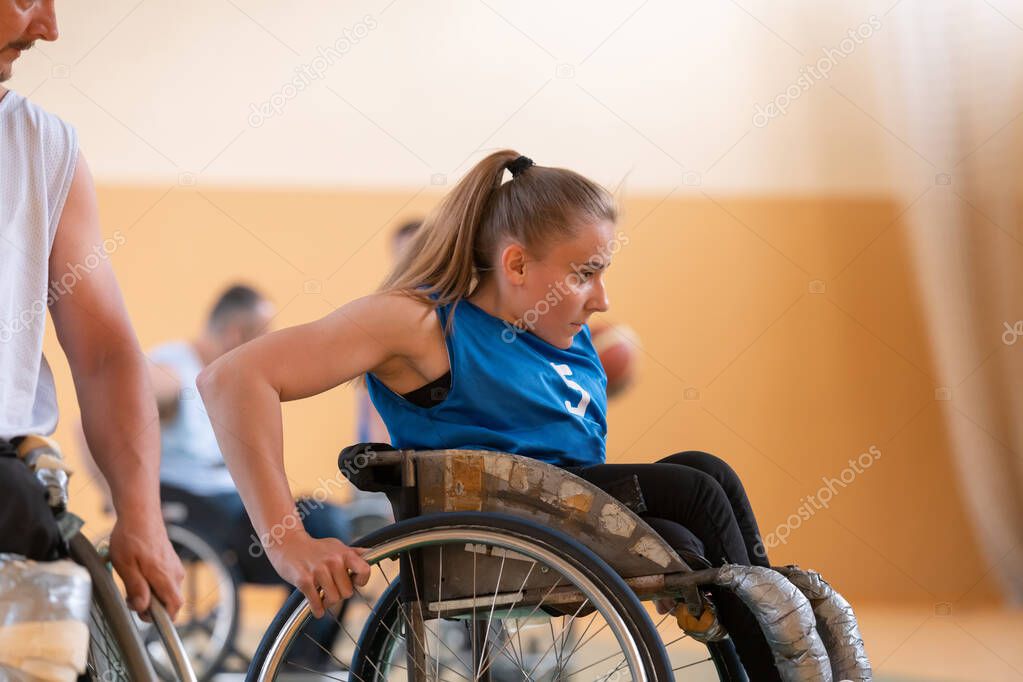 a young woman playing wheelchair basketball in a professional team. Gender equality, the concept of sports with disabilities. 