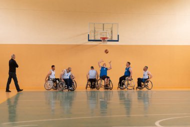 Sakat savaş gazileri basketbol sahasında basketbol oynarken engelliler için profesyonel spor ekipmanları kullanıyorlar.