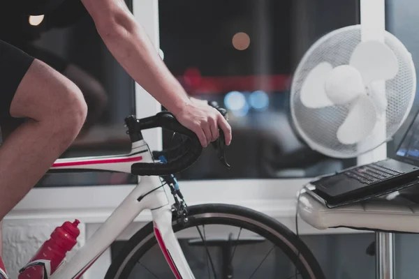 Man Cycling Machine Trainer Exercising Home Night Playing Online Bike — Stock Photo, Image