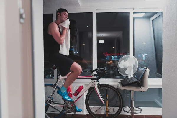 Man Cycling Machine Trainer Exercising Home Night Playing Online Bike — Stock Photo, Image