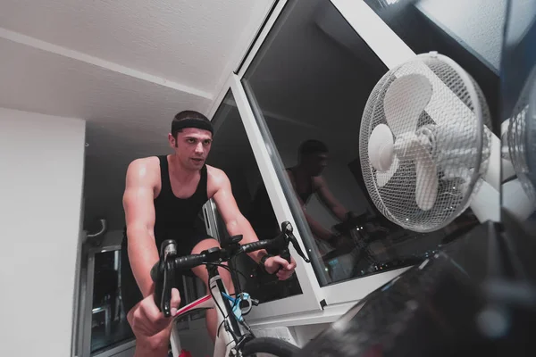 Man Cycling Machine Trainer Exercising Home Night Playing Online Bike — Stock Photo, Image