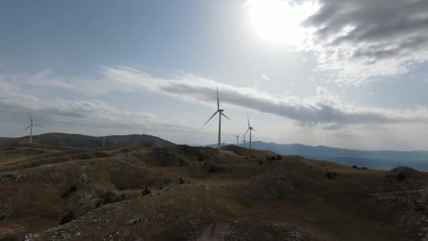 Windturbines bij zonsopgang. Windmolenpark genereert groene energie. Fpv luchtdoelvlieg. — Stockvideo
