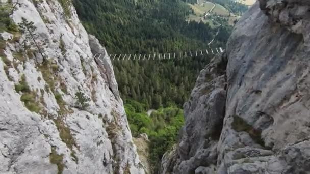 Aerial cinematic shot high speed sport fpv drone flying over natural mountain cliff surrounded Amazing nature rocky terrain with green vegetation. — Vídeos de Stock