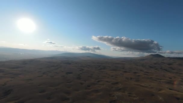 Aerial FPV drone shot of a chasing and flying close around herd of wild horses running on a field at beautiful summer sunset. — Stock Video