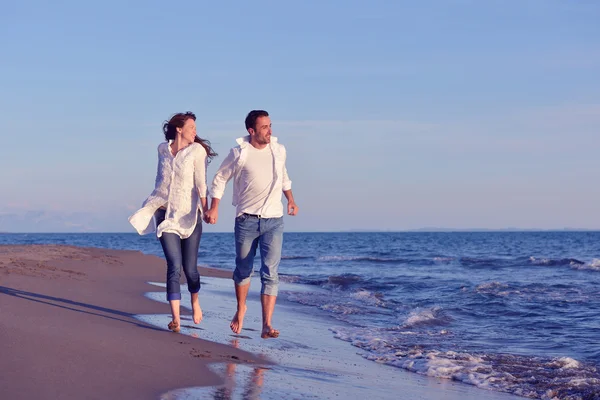 Młoda para na plaży zabawy — Zdjęcie stockowe