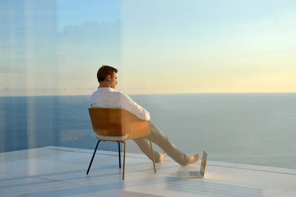 Relaxed young man at home on balcony — Stock Photo, Image