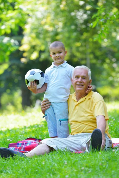 Happy grandfather and child in park — Stock Photo, Image