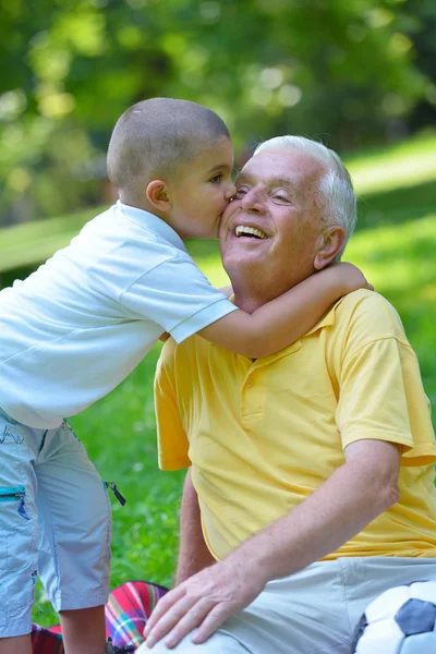 Happy grandfather and child in park — Stock Photo, Image