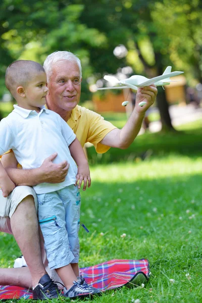 Happy grandfather and child in park — Stock Photo, Image