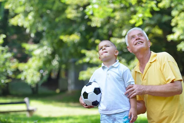 Happy grandfather and child in park — Stock Photo, Image