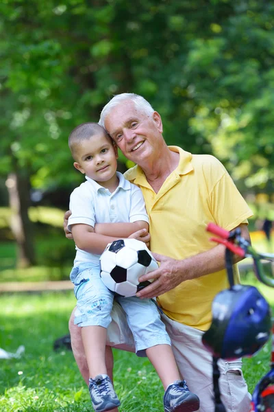 Happy grandfather and child in park — Stock Photo, Image